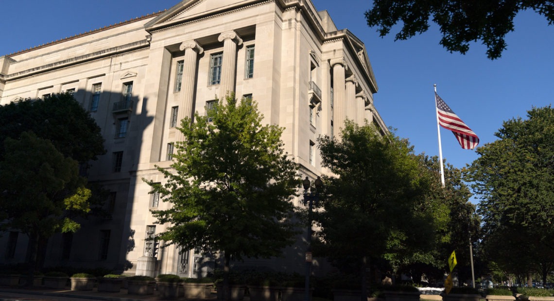 The American flag flies outside of the Justice Department building, Thursday, Oct. 8, 2020, in Washington. (AP Photo/Jacquelyn Martin)