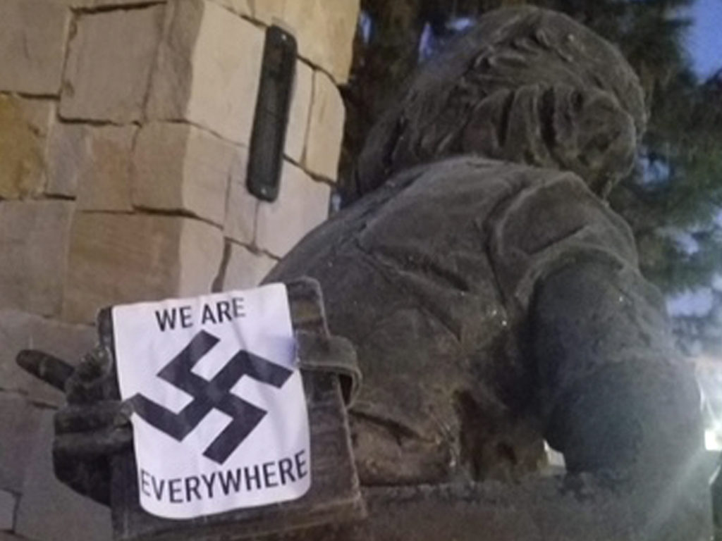 A swastika sticker on a statue at the Idaho Anne Frank Human Rights Memorial in Boise. The vandalism took place sometime between Monday evening and Tuesday morning, Boise police said. Wassmuth Center for Human Rights via AP