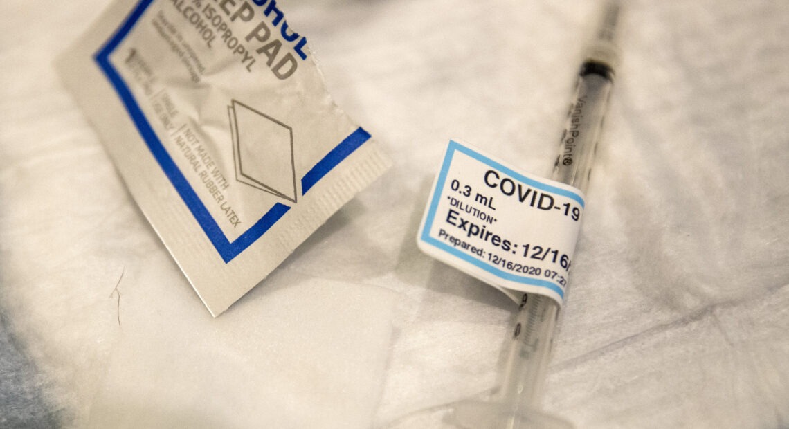 An empty syringe on a table at Ronald Reagan UCLA Medical Center after a care worker received the COVID-19 vaccine on Dec. 16, 2020. CREDIT: Brian van der Brug/AP