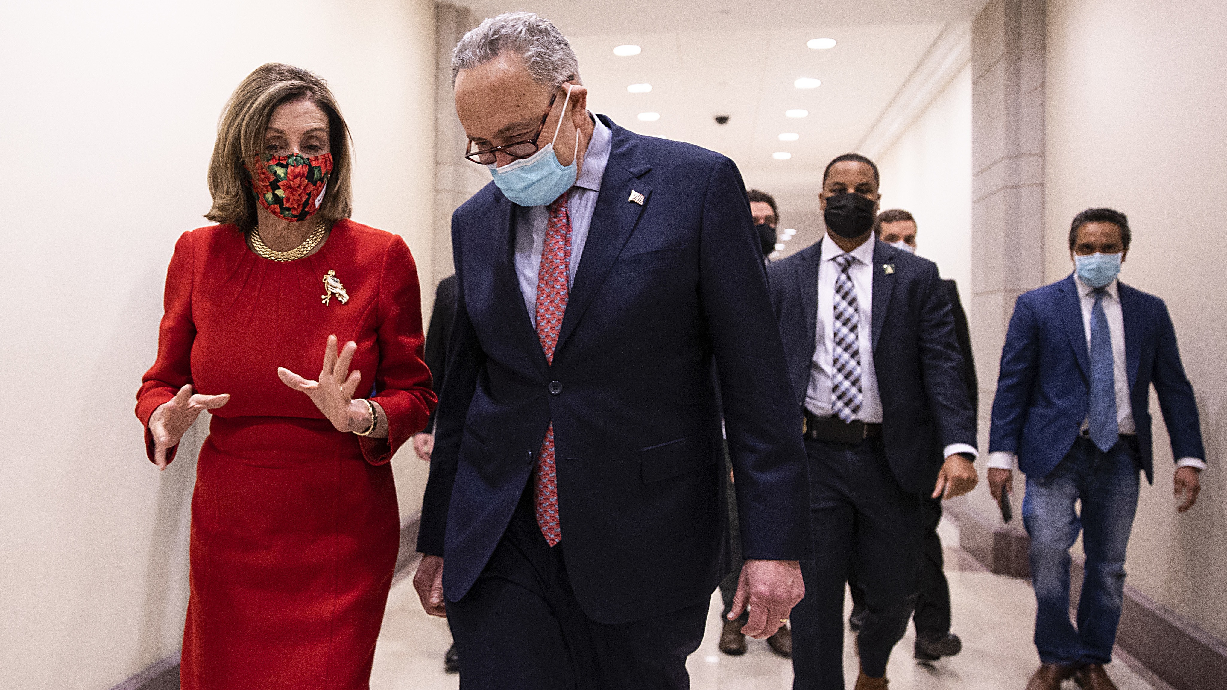 House Speaker Nancy Pelosi, D-Calif., and Senate Minority Leader Chuck Schumer, D-N.Y., speak Sunday following a press conference on Capitol Hill after Republicans and Democrats finally came to an agreement on the coronavirus relief bill. CREDIT: Tasos Katopodis/Getty Images