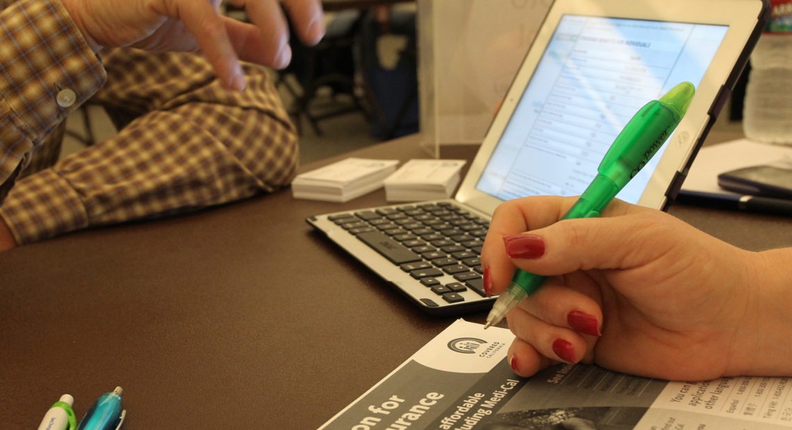 filling out health insurance sign-up paperwork