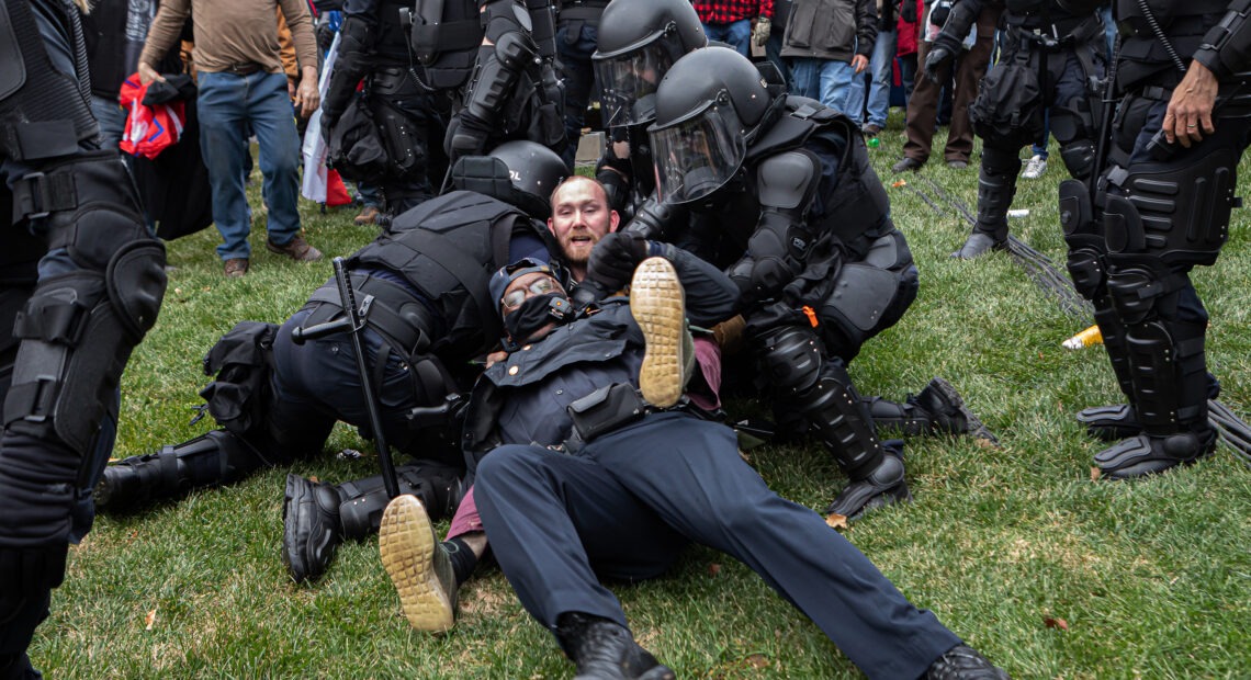 A pro-Trump protester resists arrest on Wednesday. There were few arrests in relation to the scope of the unrest as of Wednesday night. CREDIT: Michael Nigro/Sipa USA via Reuters