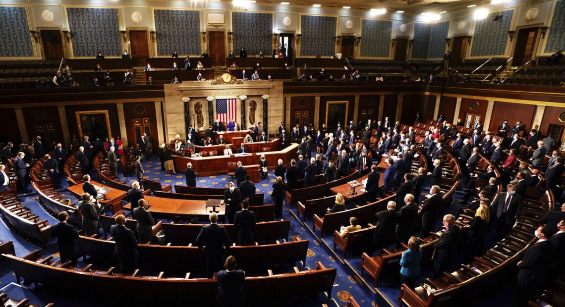 Speaker of the House Nancy Pelosi, D-Calif., and Vice President Mike Pence officiated as a joint session of the House and Senate worked to confirm the Electoral College votes cast in November's election. Jim Lo Scalzo/AP