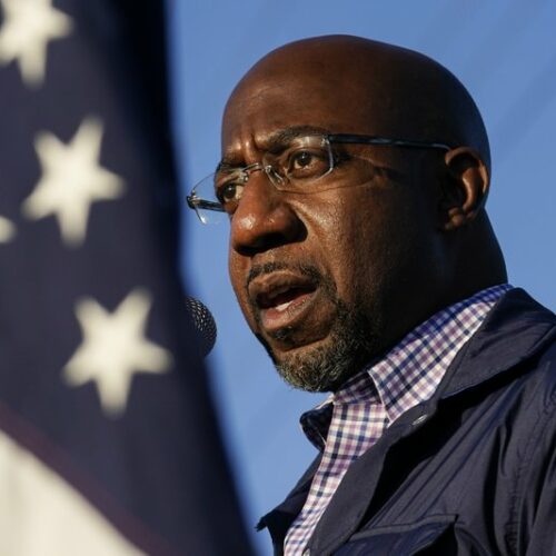 Raphael Warnock, a Democratic candidate for the U.S. Senate, speaks during a Nov. 15, 2020, campaign rally in Marietta, Ga., ahead of the Jan. 5, 2021 run-off election. As the head of the Atlanta church where Martin Luther King Jr. preached, Warnock did not shy away from impassioned sermons and forceful advocacy on behalf of the poor and disadvantaged. CREDIT: Brynn Anderson/AP