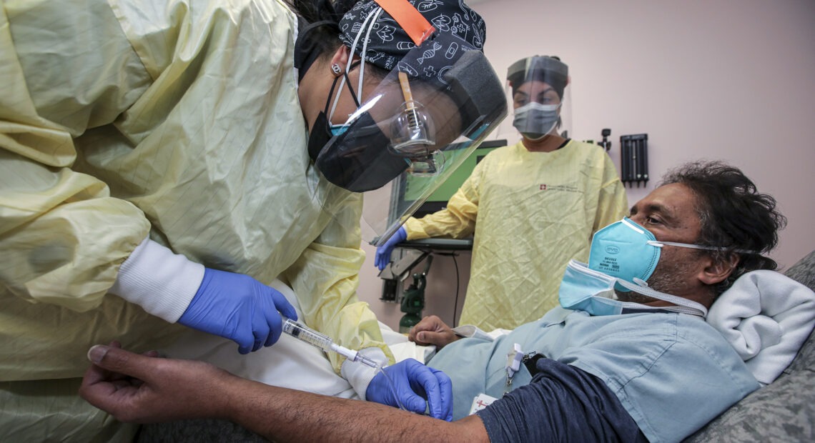 Nurse Salina Padilla prepares an infusion of a COVID-19 antibody treatment at Desert Valley Hospital in Victorville, Calif., in December. CREDIT: Irfan Khan/Los Angeles Times via Getty Images