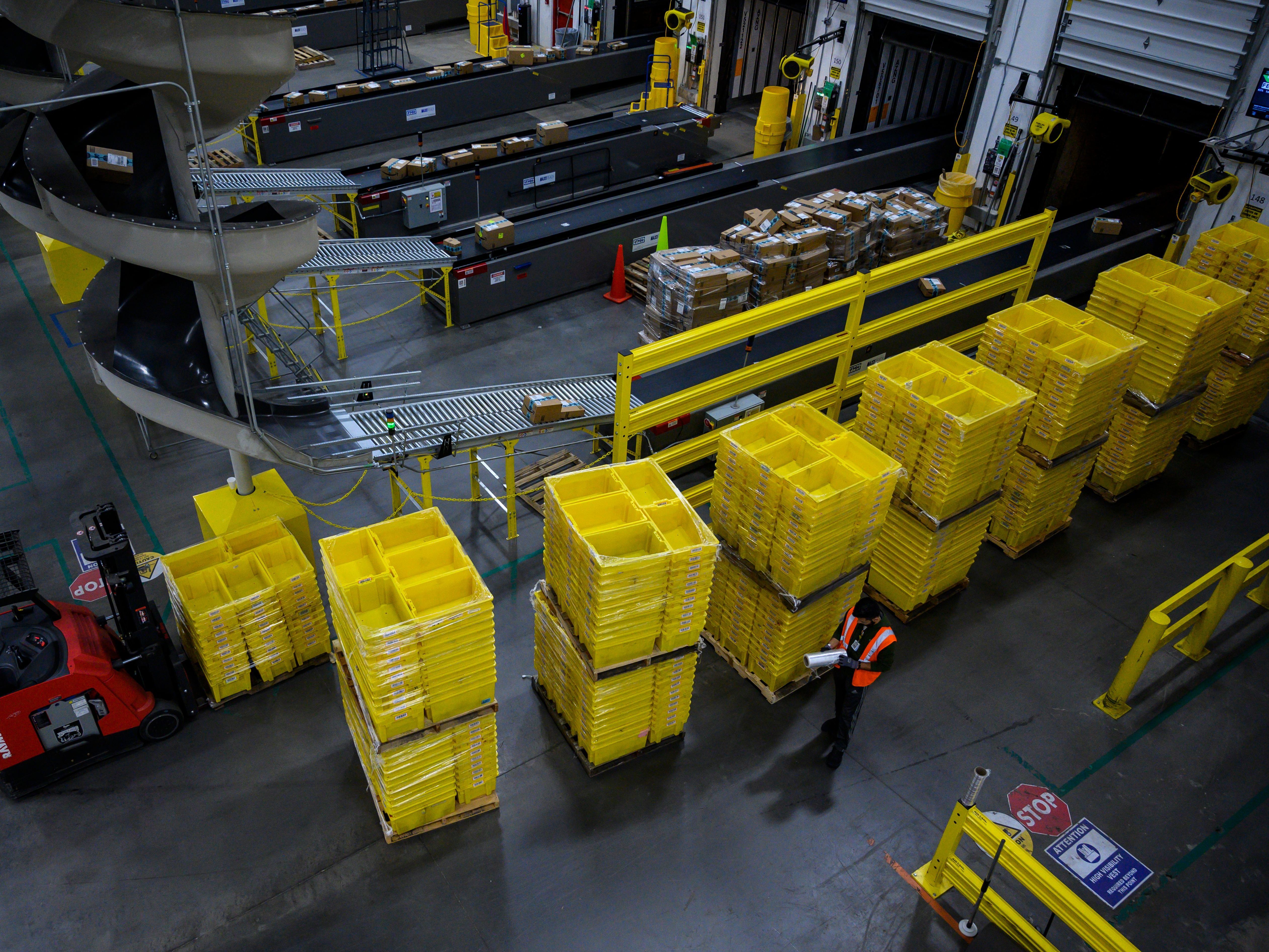 A man works at an Amazon fulfillment center in Staten Island, New York. The retail giant faces a major labor battle with a unionization vote planned at a similar warehouse in Alabama. CREDIT: Johannes Eisele/AFP via Getty Images