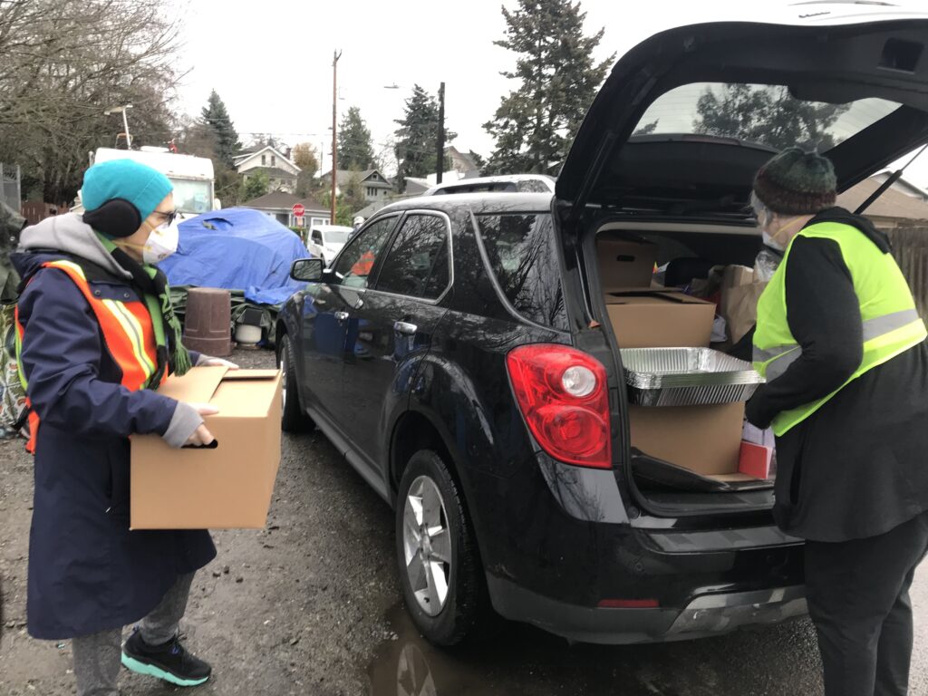 The waste-pumping program is carried out in coordination with volunteers from the local charity, St. Vincent de Paul, who bring along food and medical supplies. CREDIT: Erin Slomski-Pritz/NPR