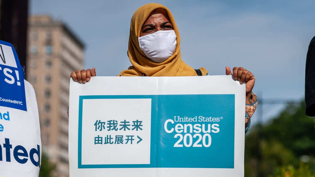 A census supporter holds up a sign during a 2020 rally in New York City. CREDIT: Gabriele Holtermann-Gorden/Sipa USA via Reuters