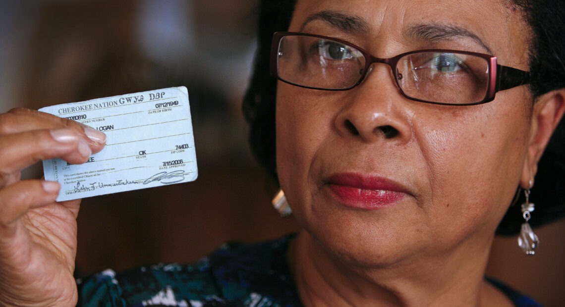 Rena Logan, a member of a Cherokee Freedmen family, shows her identification card as a member of the Cherokee tribe at her home in Muskogee, Okla., in this photo from October 2011. She is among the some 8,500 people whose ancestors were enslaved by the Cherokee Nation in the 1800s. CREDIT: David Crenshaw/AP