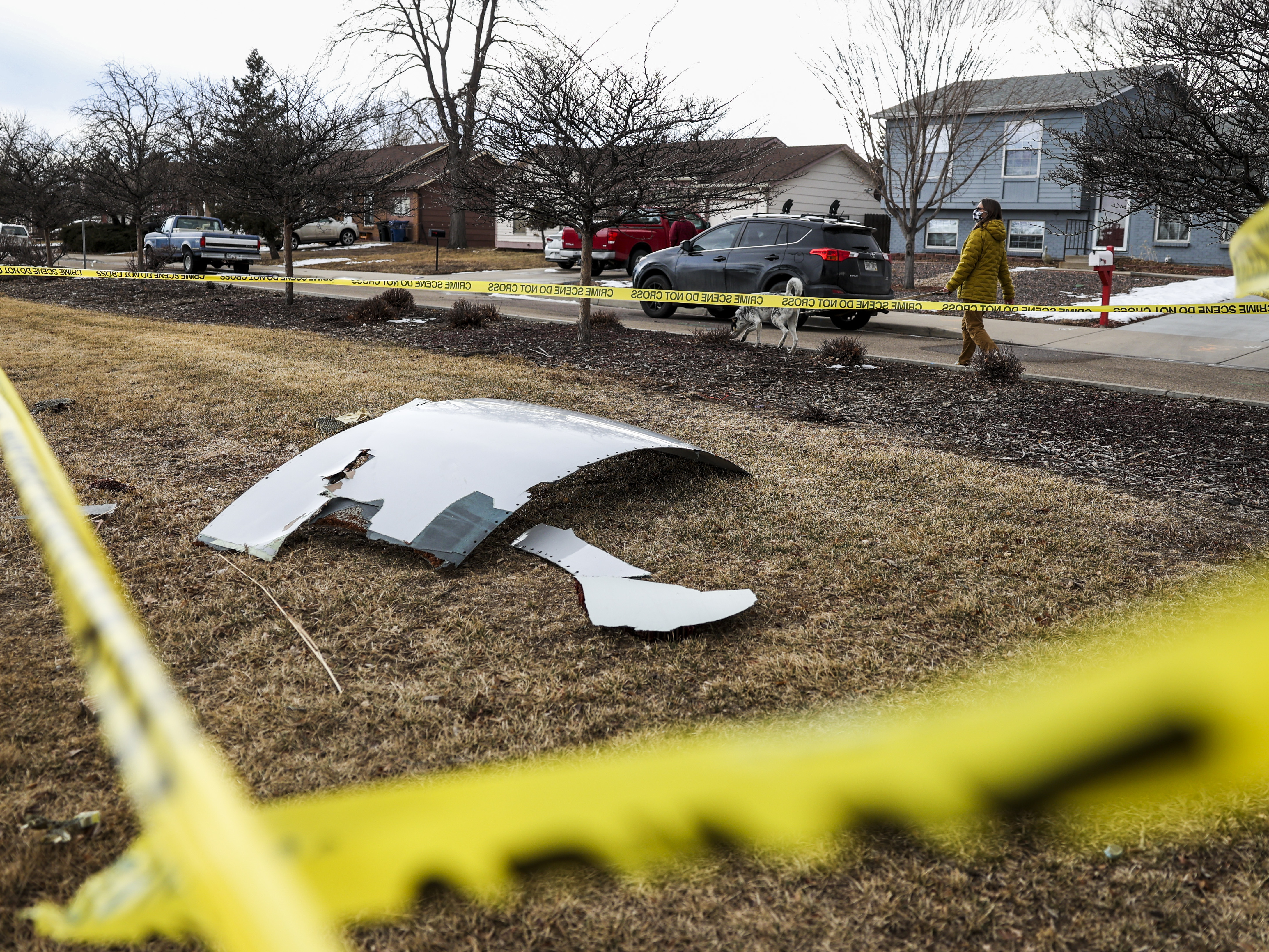 Pieces of an engine from United Airlines Flight 328 sit scattered in a neighborhood after the jet's engine failure on Saturday after takeoff from Denver. CREDIT: Michael Ciaglo/Getty Images