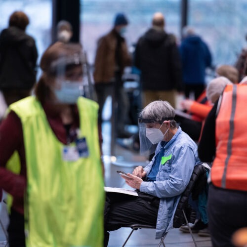 Workers and patients at a pop-up COVID-19 vaccination site near downtown Seattle in January. "The vast majority who are coming in do appear to be meeting the eligibility criteria," says Dr. Jeff Duchin, King County's public health officer. Grant Hindsley/AFP via Getty Images