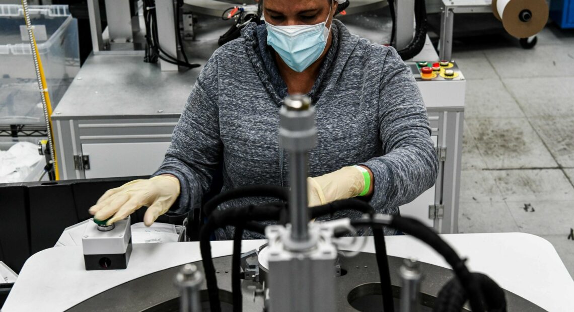 An employee makes respiratory masks in a family-owned medical equipment factory in Miami on Feb. 15. American manufacturers are thriving but they are running into an unexpected problem: finding critical supplies. CREDIT: Chandan Khanna/AFP via Getty Images