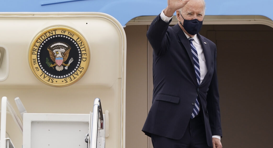 President Joe Biden waves before boarding Air Force One