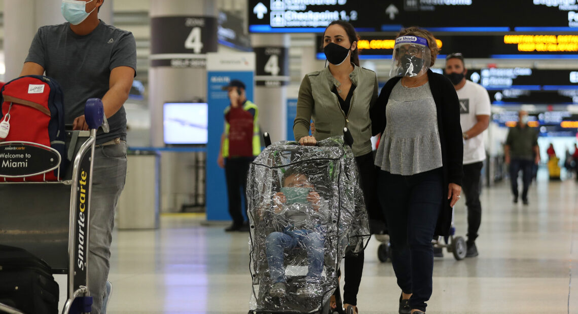 With precautions such as mask-wearing in place, experts predict travel is among the activities that may become safer by this summer. CREDIT: Joe Raedle/Getty Images