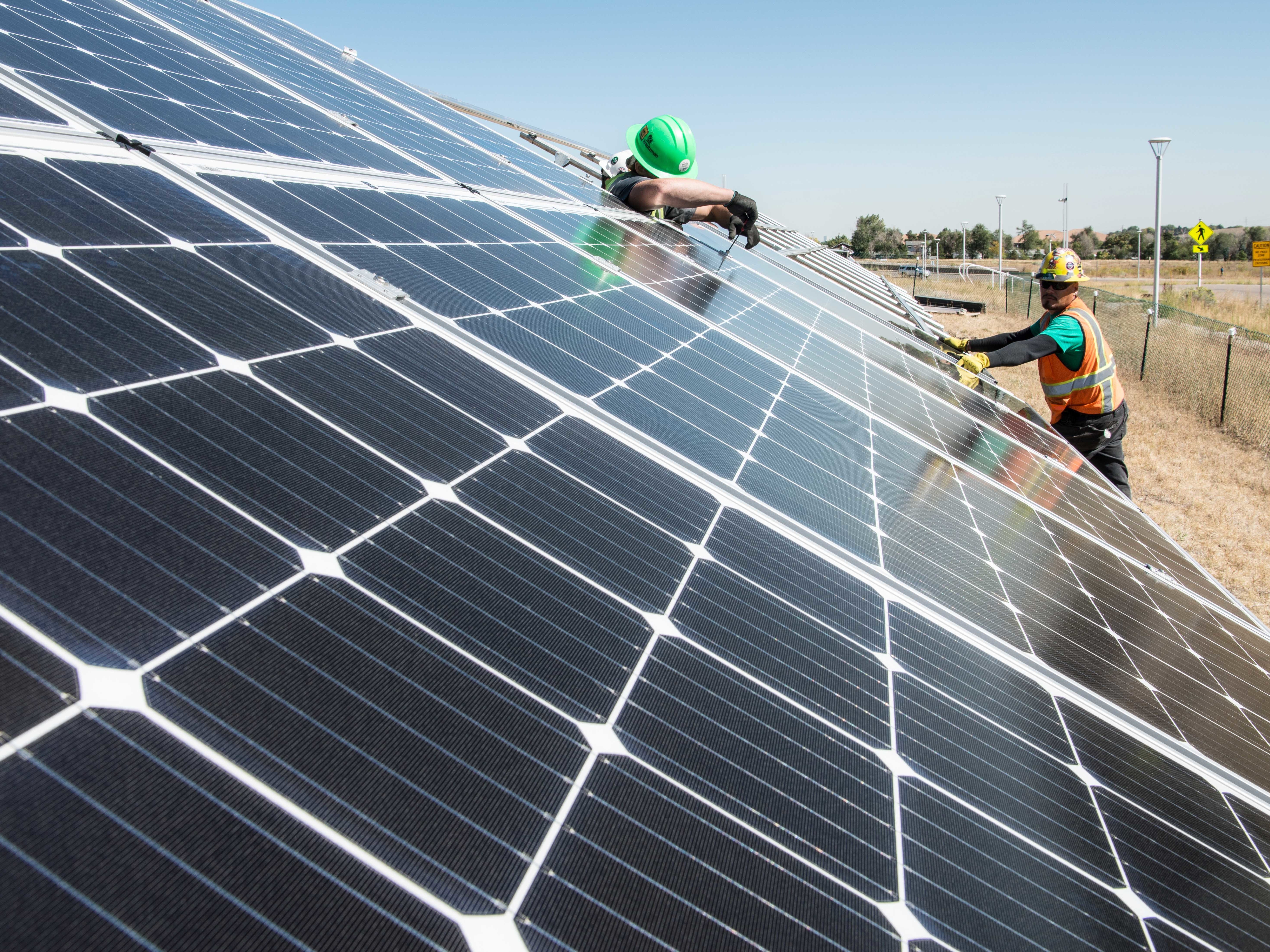 September 28, 2016 - Workers with Zilla Rack install PV modules on two racks just north of the NREL parking garage. The first row modules are part of a project called the Regional Test Centers (RTCs), small demonstration systems for PV industry to help get some initial performance validation and bankability study from the national labs.. The PV modules in the second row are part of a new DOE program called PV Lifetime. The intent is to study with high accuracy the initial degradation of PV modules, and to make all of the data publicly available. (Photo by Dennis Schroeder / NREL)