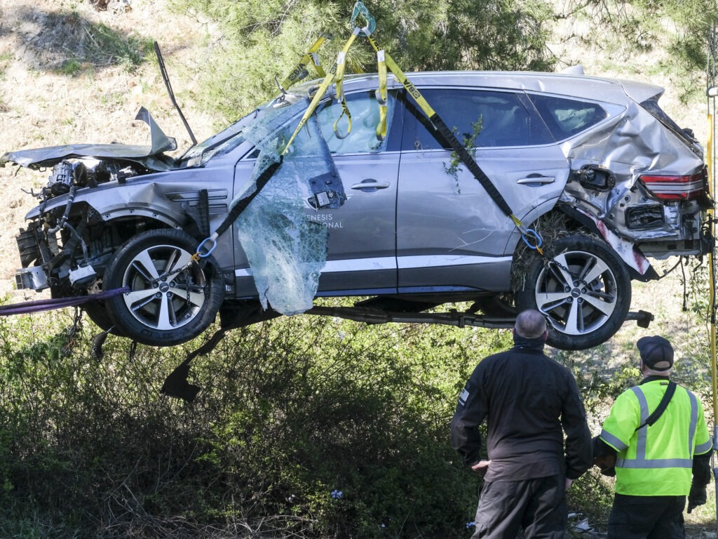 A crane is used to lift a vehicle driven by golfer Tiger Woods following a rollover accident in February in the Rancho Palos Verdes suburb of Los Angeles. CREDIT: Ringo H.W. Chiu/AP