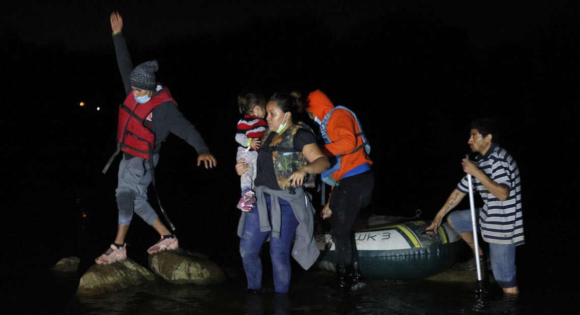 A group of migrants from El Salvador arrives in Roma, Texas, after crossing the Rio Grande on March 30, 2021 in Roma, Texas. CREDIT: Joe Raedle/Getty Images