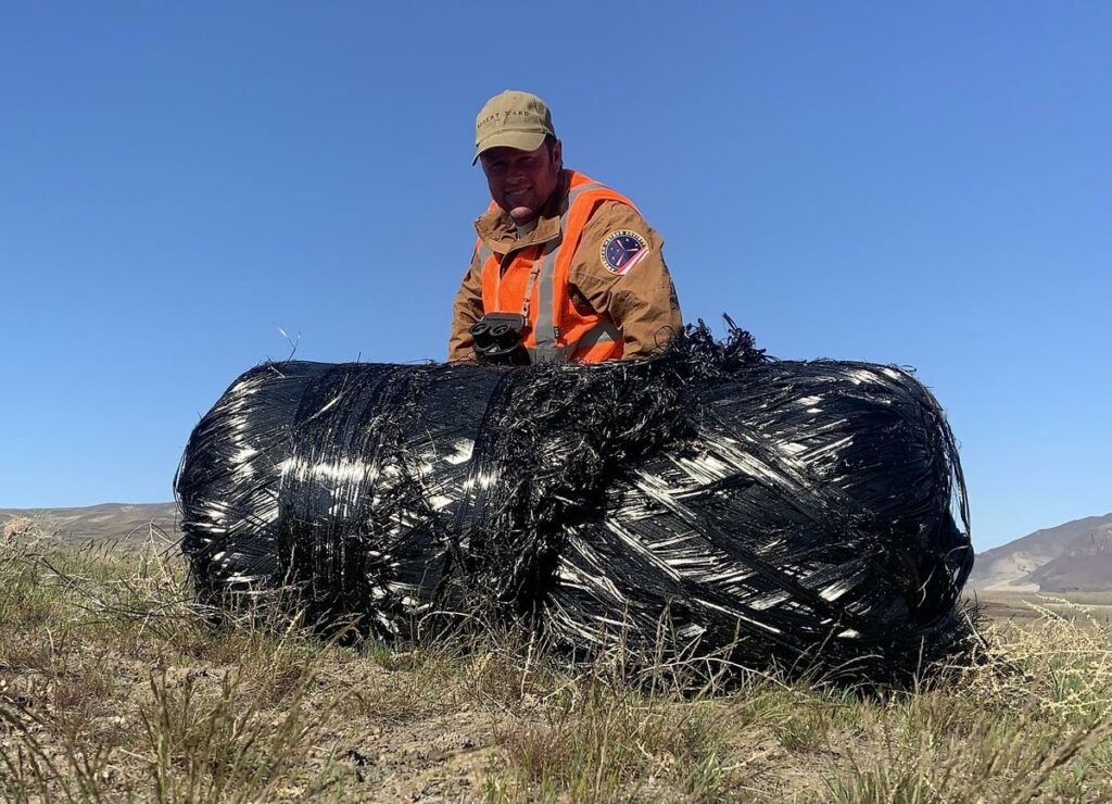 Robert Ward posed with the second carbon fiber-wrapped rocket tank he found, which he located close to the Columbia River on the Yakima Firing Range.