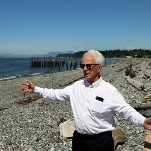 Point Roberts Chamber of Commerce President Brian Calder at a beach left deserted by cross-border travel restrictions. CREDIT: Tom Banse/N3