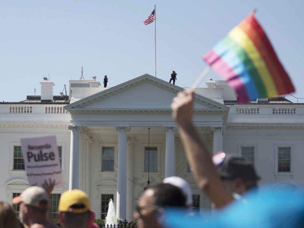 In this June 11, 2017 file photo, Equality March for Unity and Pride participants march past the White House in Washington. The Biden administration says the government will protect gay and transgender people against sex discrimination in health care. That reverses a Trump-era policy that sought to narrow the scope of legal rights in sensitive situations involving medical care. Health and Human Services Secretary Xavier Becerra said Monday that LGBTQ people should have the same access to health care as everyone else. T(AP Photo/Carolyn Kaster)