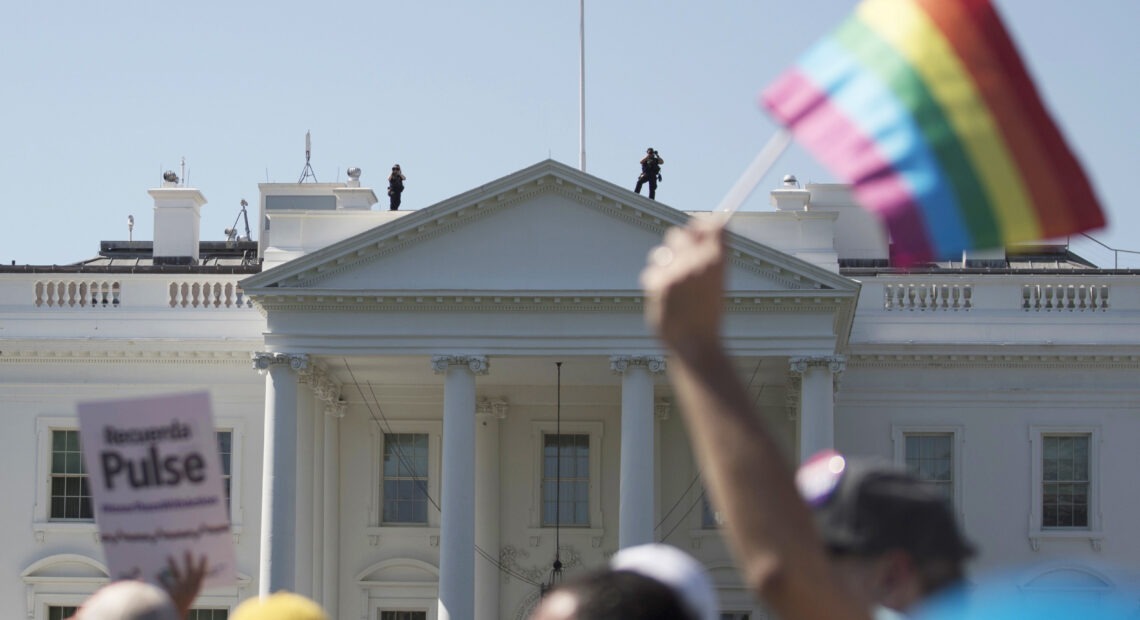 In this June 11, 2017 file photo, Equality March for Unity and Pride participants march past the White House in Washington. The Biden administration says the government will protect gay and transgender people against sex discrimination in health care. That reverses a Trump-era policy that sought to narrow the scope of legal rights in sensitive situations involving medical care. Health and Human Services Secretary Xavier Becerra said Monday that LGBTQ people should have the same access to health care as everyone else. T(AP Photo/Carolyn Kaster)