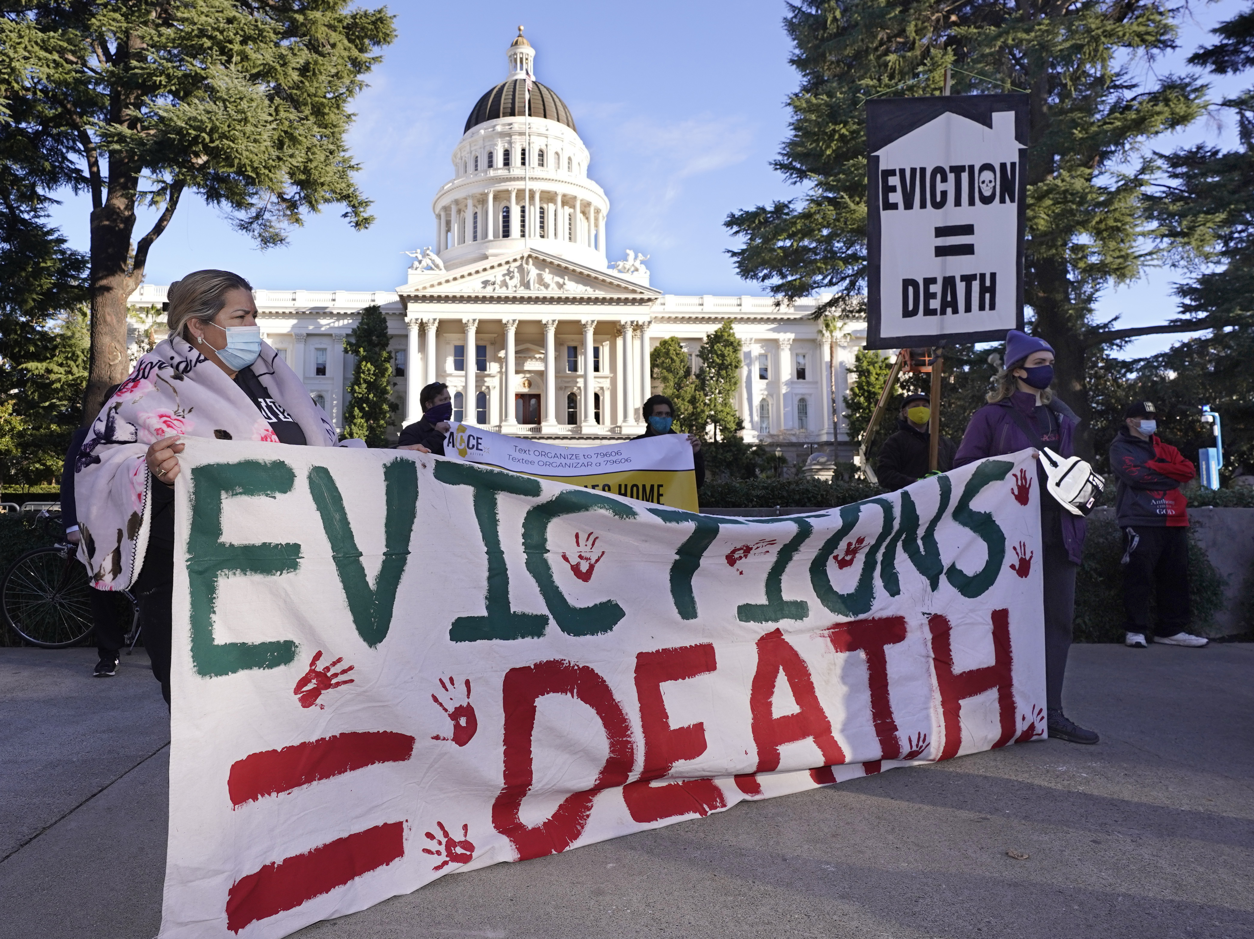 Protesters call for stronger eviction protections in January in Sacramento, Calif. A federal appeals court will now decide whether to scrap a federal eviction moratorium from the CDC. Housing groups say renters need more time to qualify for and get rental assistance money. CREDIT: Rich Pedroncelli/AP