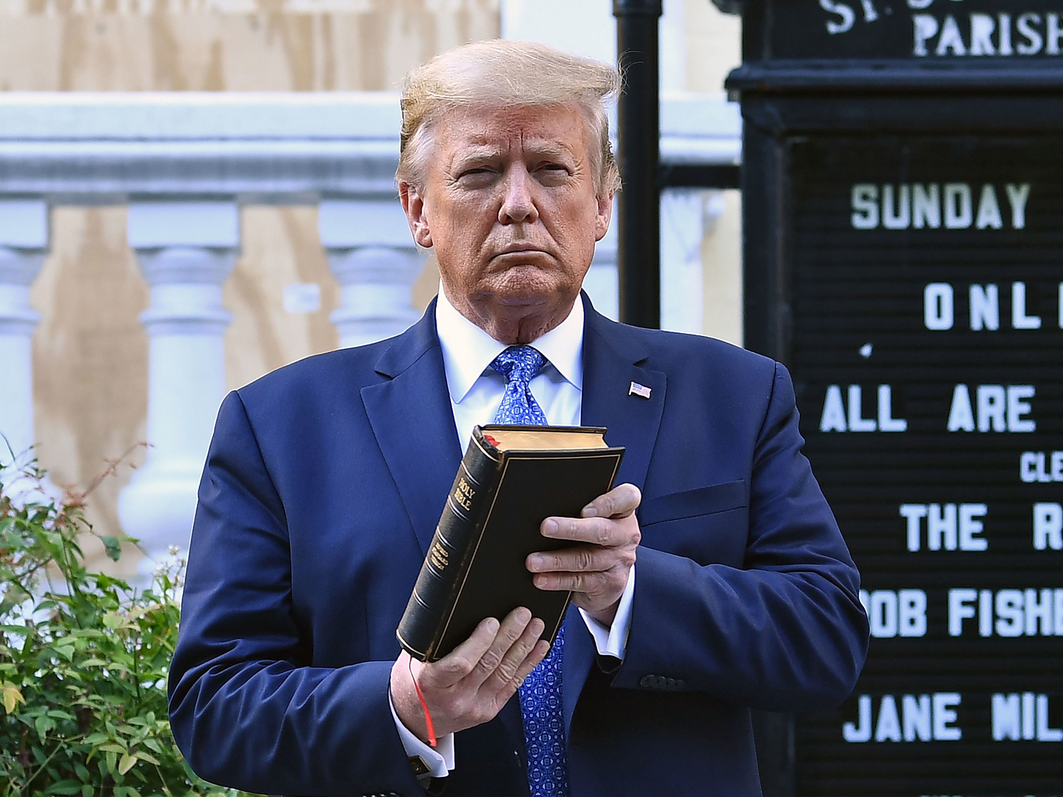 Then-President Donald Trump holds up a Bible outside St. John's Episcopal Church in Washington, D.C., last June after days of anti-racism protests against police brutality. President Biden has rescinded several orders Trump made during his last year in office, including moves to protect Confederate statues targeted by protesters. Brendan Smialowski/AFP via Getty Images