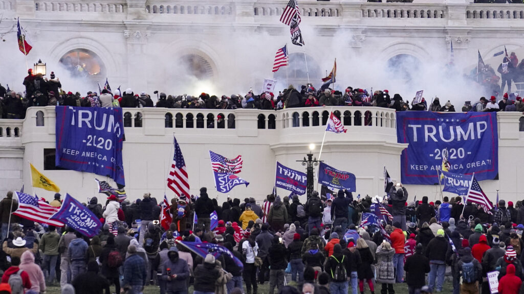 Violent rioters supporting then-President Donald Trump storm the U.S. Capitol on Jan. 6. Capitol Police had seen information from a pro-Trump website that encouraged demonstrators to bring weapons to subdue members of Congress and police. CREDIT: John Minchillo/AP