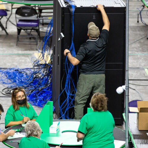 Contractors working for Cyber Ninjas, the company hired by the Republican-led Arizona state Senate, examine and recount ballots from the 2020 general election on May 3. Courtney Pedroza/The Washington Post via Getty Images