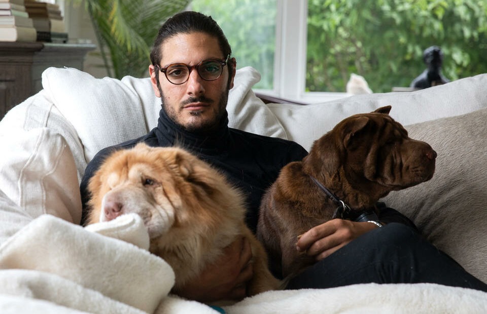 Abraham Dairi spends time with his dogs Ziggy, 3, and Bowie, 4, at his home in Seattle's Montlake neighborhood on July 1, 2021. CREDIT: Matt M. McKnight/Crosscut