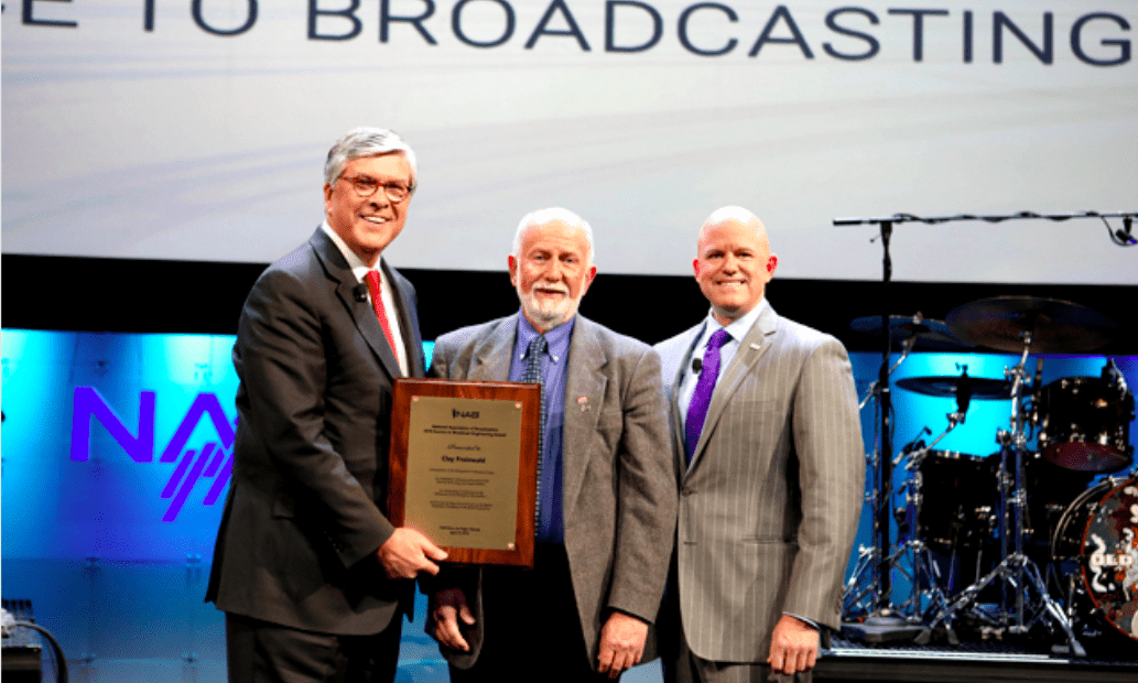 image shows Clay Freinwald on stage receiving award.