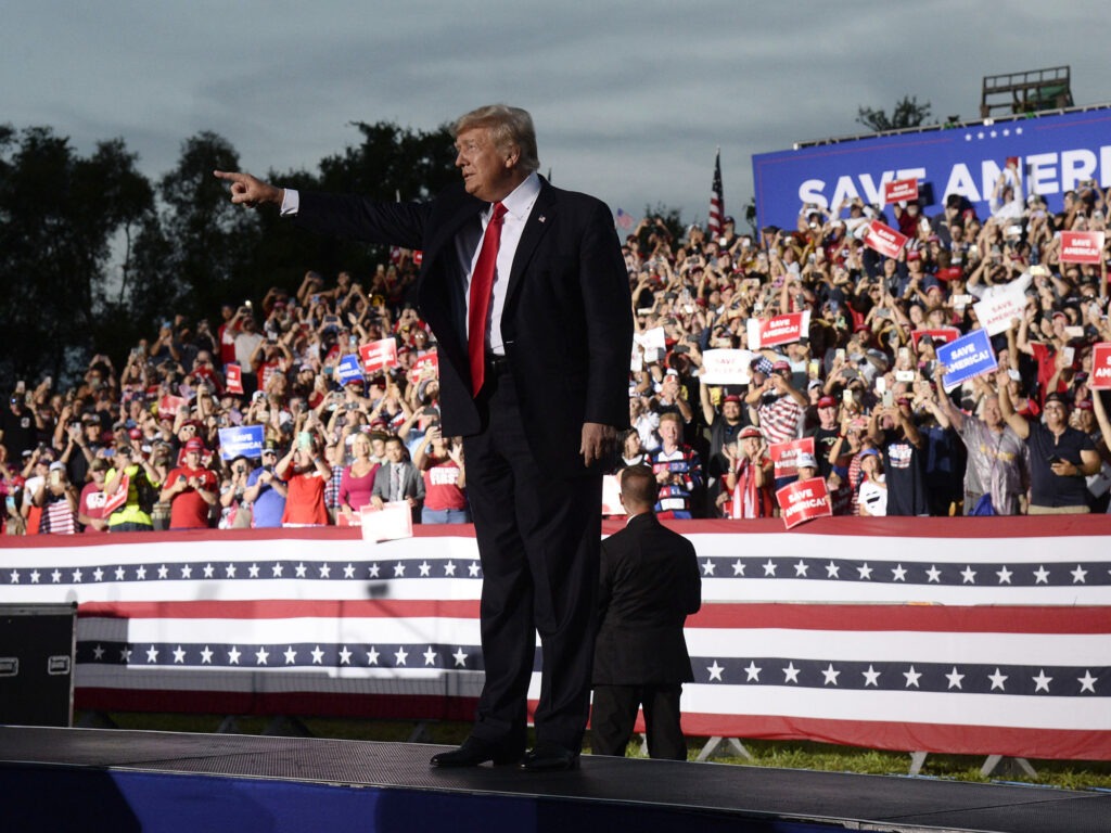 Former President Donald Trump has announced that he is suing three of the country's biggest tech companies: Facebook, Twitter and Google's YouTube. Here, he walks onstage during a rally on July 3 in Sarasota, Fla. CREDIT: Jason Behnken/AP