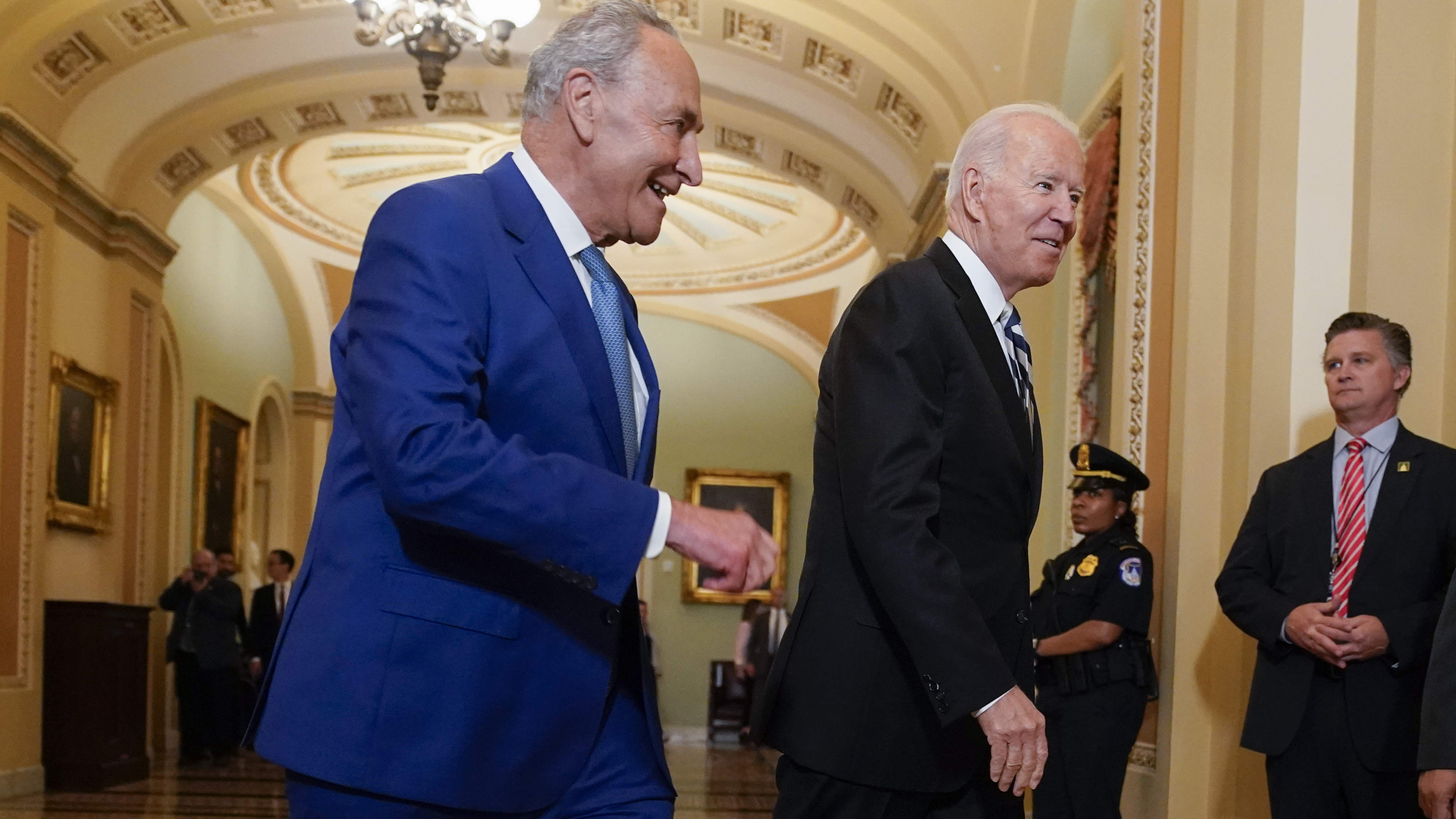 President Biden walks with Senate Majority Leader Chuck Schumer, D-N.Y., at the Capitol on Wednesday as he arrives to discuss the latest progress on his infrastructure agenda. CREDIT: Andrew Harnik/AP