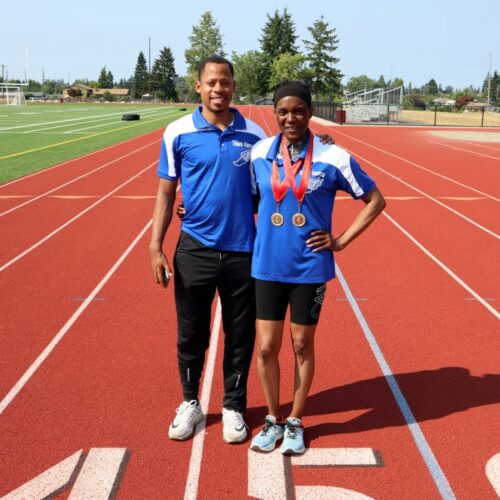 Chambers and Hanna stand on the running field together.