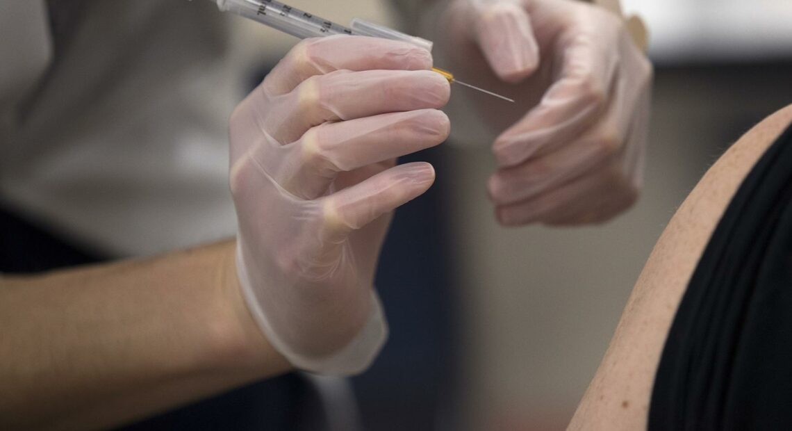 Pharmacist Rui Wen prepares to administer a Johnson & Johnson Covid-19 vaccine for an employee of the Safeway Distribution Center on Monday, March 22, 2021, in Auburn.