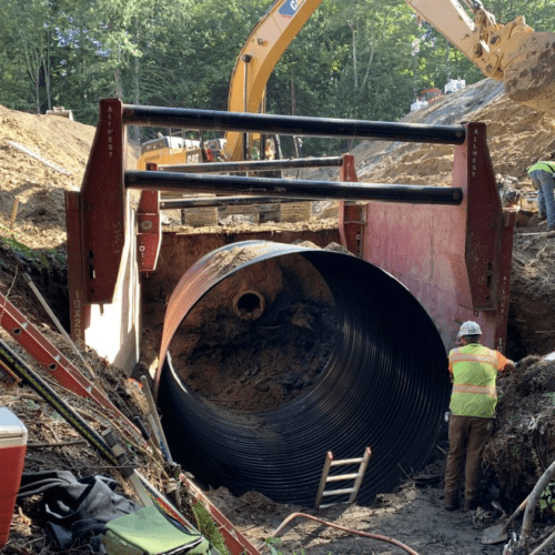 Crews in Bellingham replace an old culvert (center) with a new 12-foot diameter pipe. The old culvert was too smalland sat too high for juvenile fish to navigate during their migration to their spawning grounds.