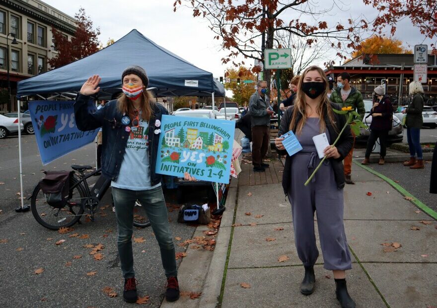 People First Bellingham campaign volunteers Seth Mangold and Sage Jones sought voter support for their coalition's four initiatives at the Bellingham Farmers Market on Saturday.