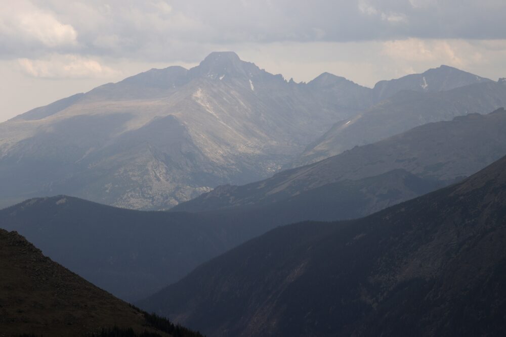 A bird's eye view of the Rocky Mountain range in varying shades of blue and grey.