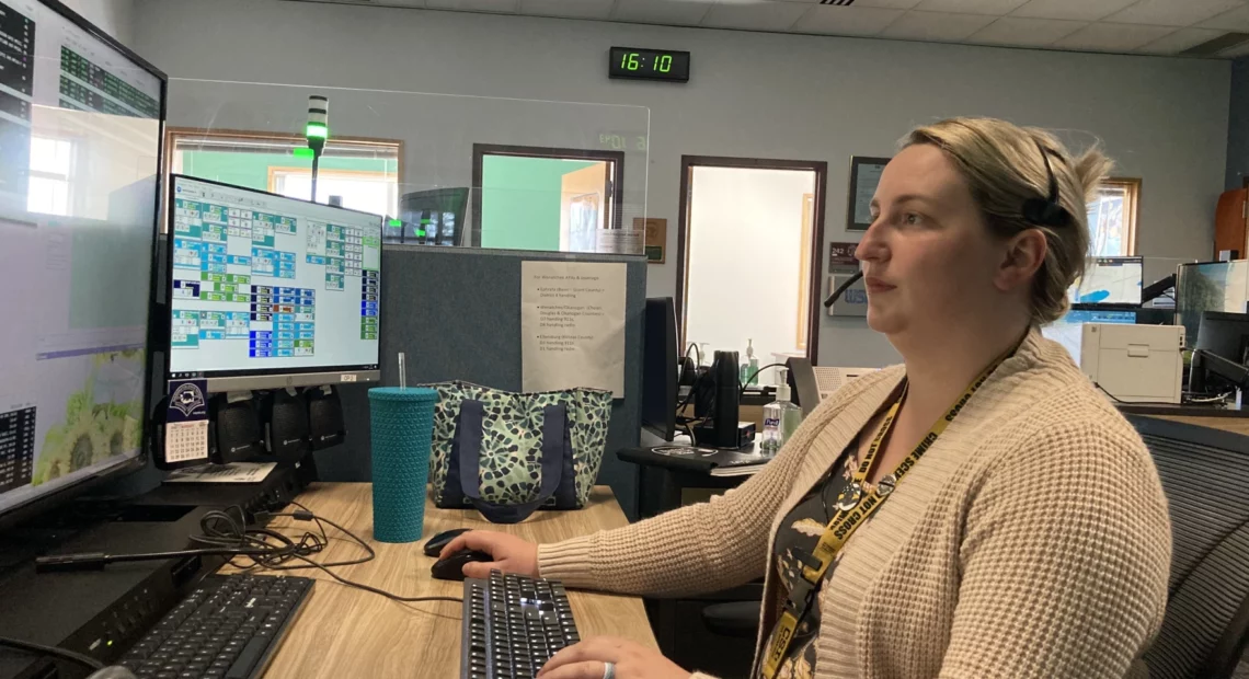 Kayla White, a Washington State Patrol dispatcher, sits at her console in the Tacoma communications office. Most weeks she works three 12-hour days, in addition to two other regular eight-hour days, to help cover ongoing staffing shortages. In addition, she and her colleagues now handle calls east of the Cascades after the Wenatchee communications center closed due to a lack of staffing.