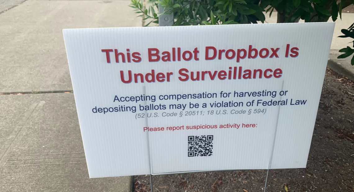 Signs like this one at the Broadview library branch in north Seattle popped up at some King County ballot drop boxes in July. They prompted concerns about voter intimidation and ultimately an investigation by the King County Sheriff's Office.