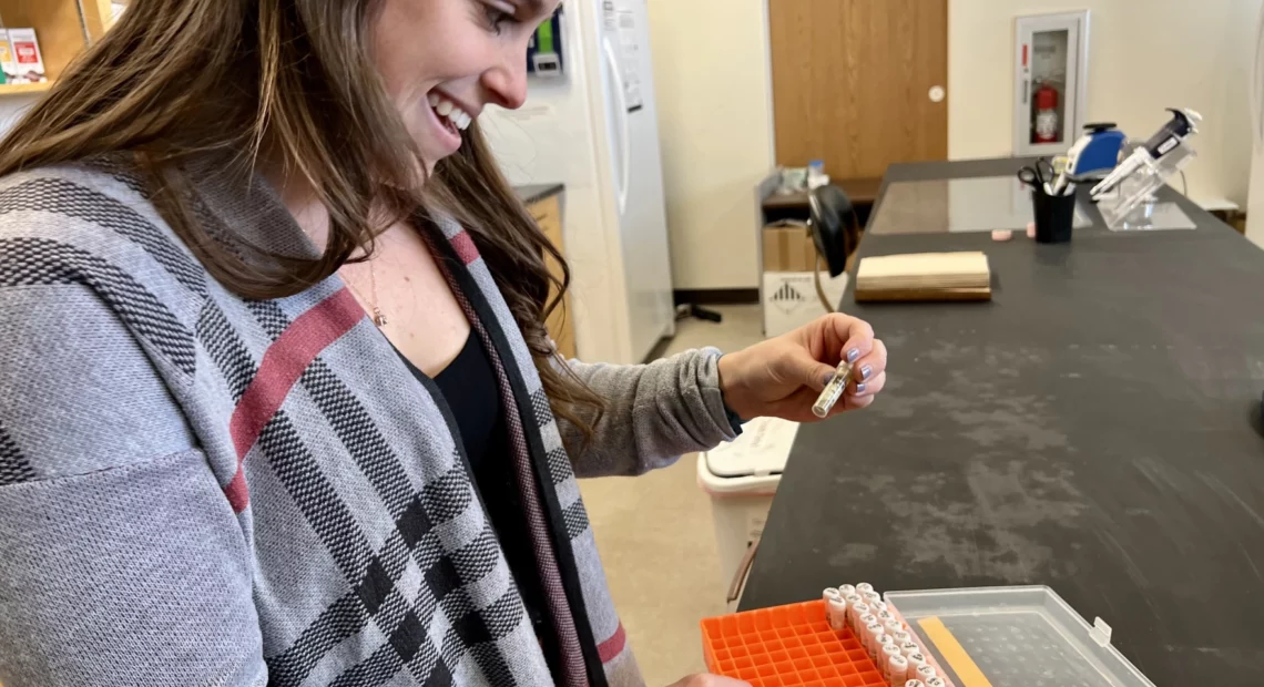 Meghan Parsley filters water to collect environmental DNA, or eDNA.