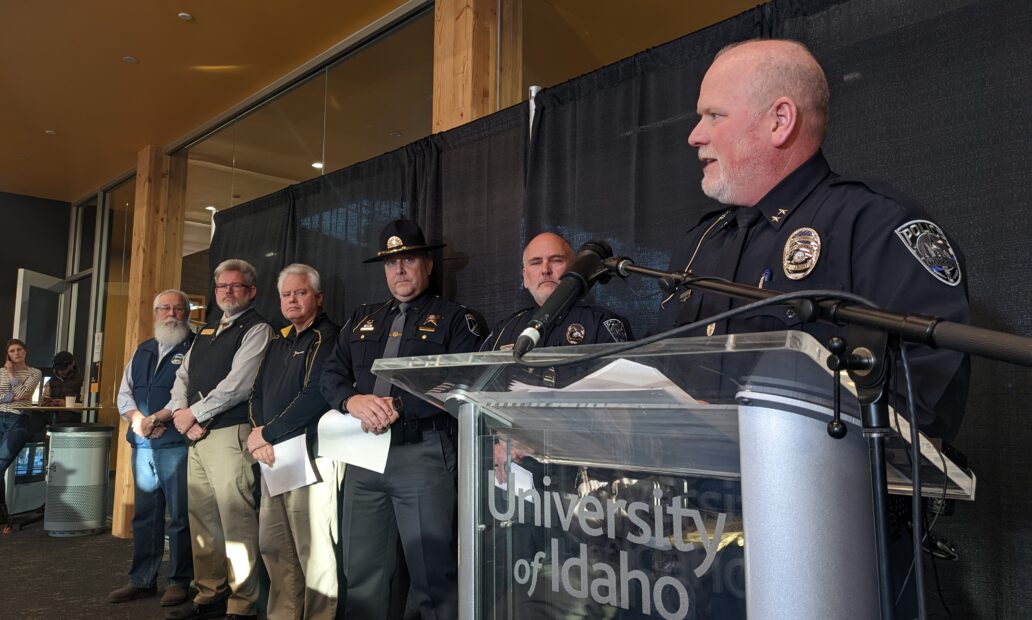 Police Chief Fry stands at a podium to address reporters.