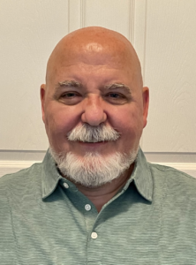 Older white man smiling at camera 