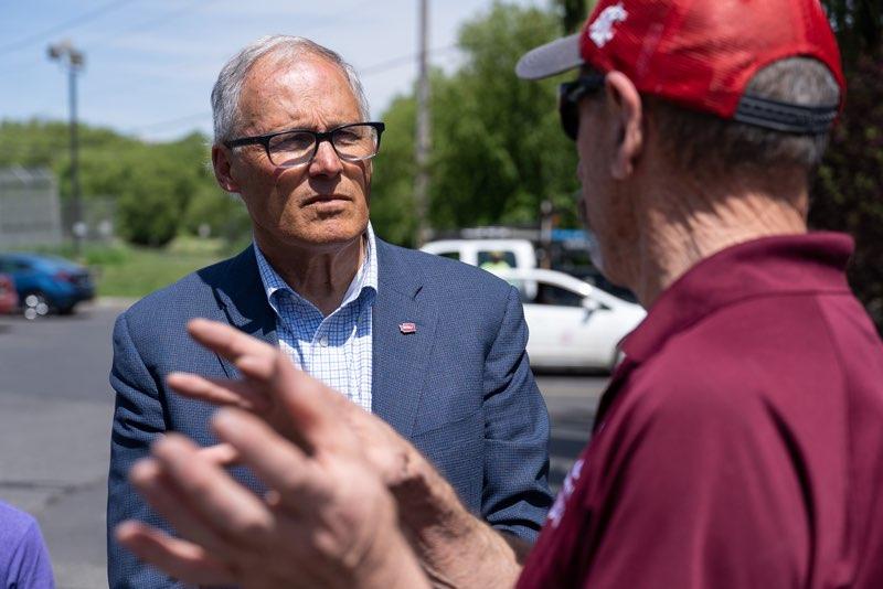 Washington Governor Jay Inslee speaking outdoors with the Mayor of Malden, Ted Maxwell.