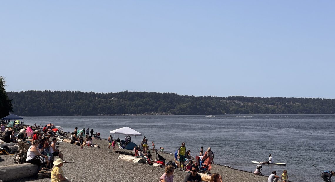 Beachgoers stay cool Monday afternoon at Owen Beach in Tacoma. (Credit: Lauren Gallup NWPB)