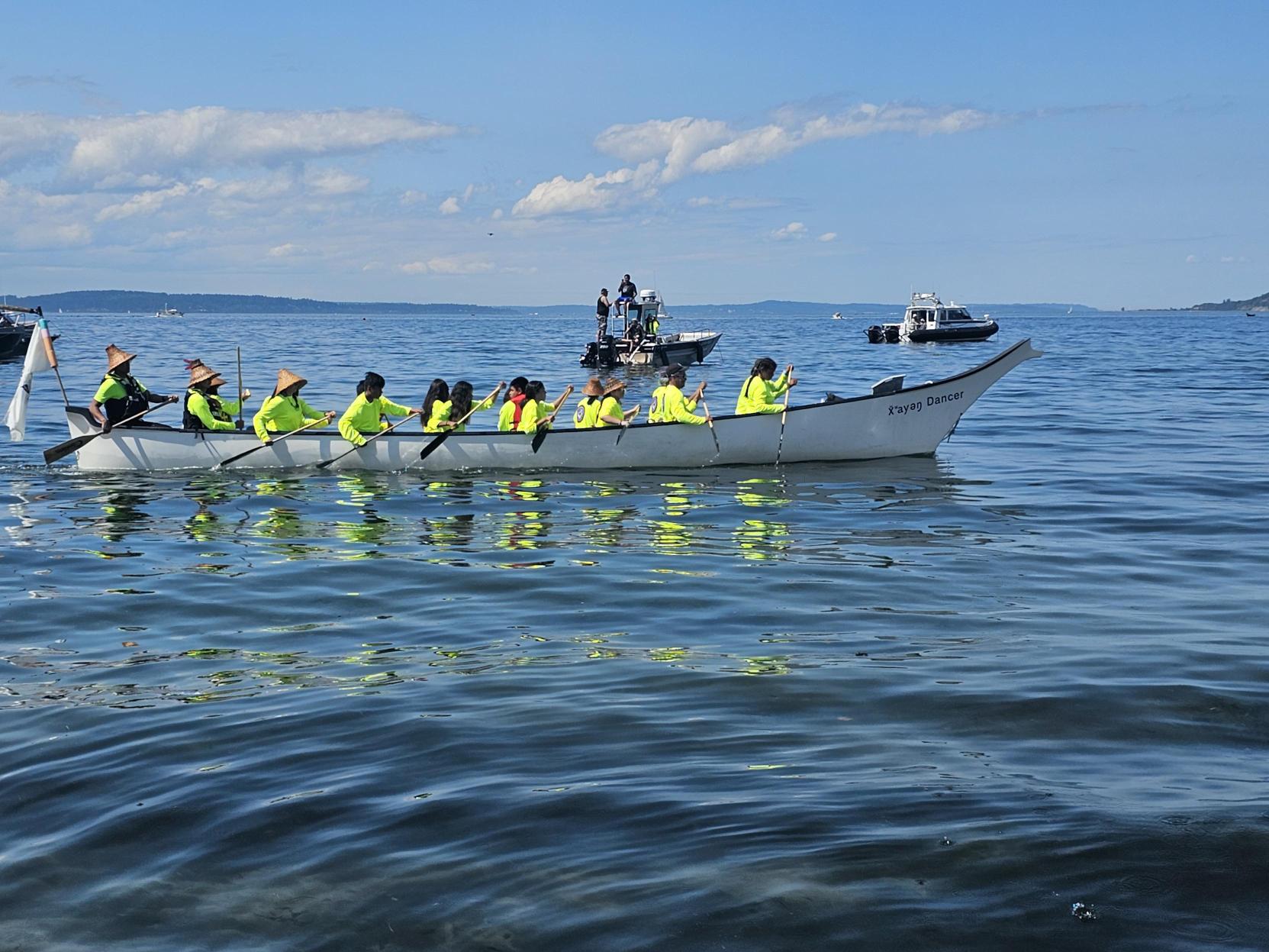 A canoe family paddles in to bring their canoe ashore and rest after a long journey. // CREDIT: Tracci Dial, NWPB