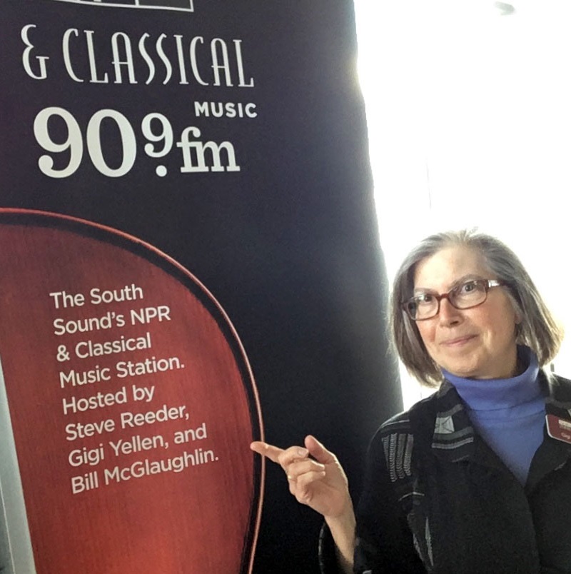 Gigi Yellen with 90.9 FM poster