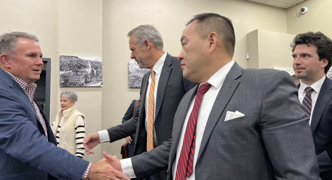 WSU athletic director Pat Chun and OSU athletic director Scott Barnes shake hands following their legal victory in Whitman County Superior Court