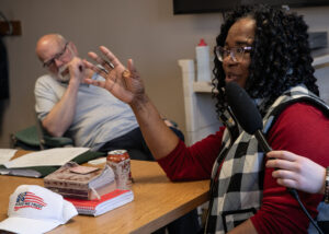 Sandra Lytle addresses her fellow community members at the political discussion group in Port Angeles on March 14. (Credit: Tela Moss / NWPB)