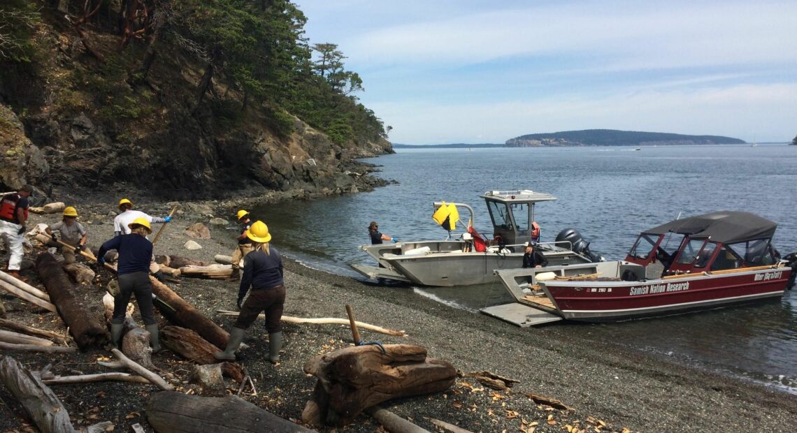 The Samish Indian Nation Department of Natural Resources works to clean up debris off the shoreline. (Credit: Samish Indian Nation Department of Natural Resources)